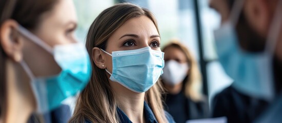 Diverse professionals in face masks engaged in a business meeting emphasizing safety protocols in a modern office environment