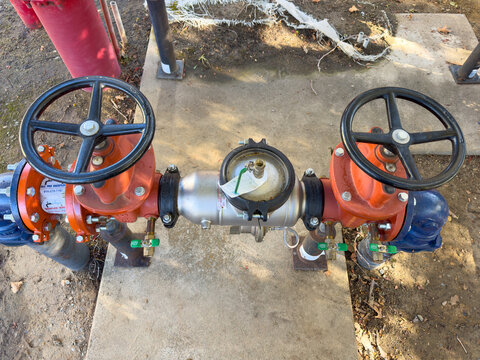 Commercial backflow device on the incoming water line outside.