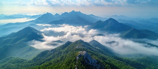 Aerial view of a scenic mountain summit surrounded by misty valleys showcasing breathtaking landscapes and popular tourist attraction.