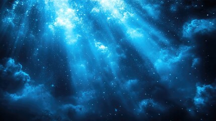 Obraz premium Beautiful blue light rays penetrating a dark underwater scene creating a serene and tranquil atmosphere for backgrounds and designs.