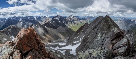 Majestic mountain landscape view from high perspective showcasing rugged peaks and expansive valleys under a dramatic cloudy sky