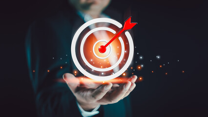 Fototapeta premium Concept of business strategy and future sustainable business action plan. Hand holding target board for creative objective target and success and business goals concept. Goal setting concept
