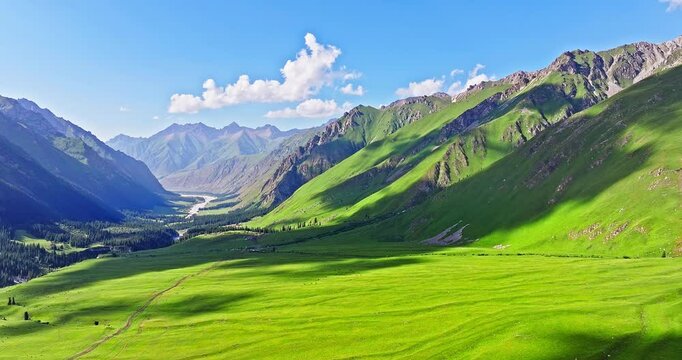 Green grassland with mountain natural landscape in Xiata Scenic Area, Xinjiang. Famous travel destinations in China. Summer scenery.