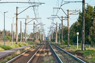 In the photo there is an electrified railway without trains