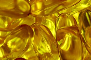 Amber tones in an abstract close up of fish oil capsules