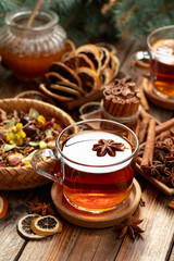 Christmas herbal tea with ingredients on a old wooden table.