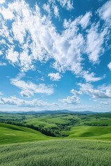 Fototapeta premium Stunning Panoramic View of Rolling Green Hills Under a Vibrant Blue Sky with Fluffy Clouds in a Serene Countryside Landscape
