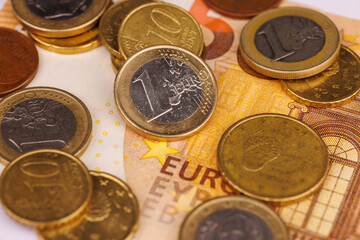 Aerial Perspective of Euro Coins on a 50 Euro Note on a White Background