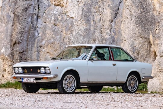 Omis, Croatia - August 31st, 2023 - Classical Fiat 124 Sport Coupe on the road. Two-door, four-seater coup&eacute; was based on 124 saloon and its  "Lampredi engine" was designed by ex-Ferrari engineer.