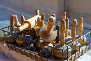 A basket full of old wooden tools, including a rolling pin