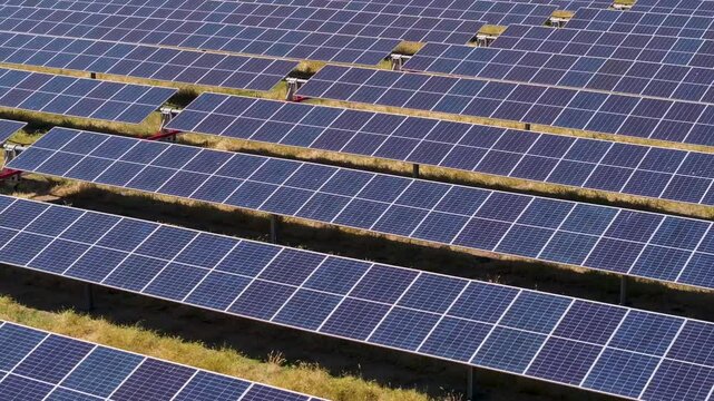 tight aerial pull pan over solar array rows of panels