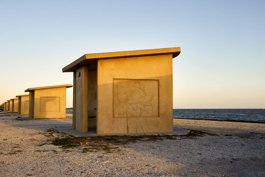 Distinctive architectural structures on the sandy shore of the G