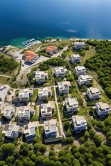 Fototapeta premium Aerial view of a stunning coastal residential area amid lush greenery and nature. An exquisite, luxurious modern villas