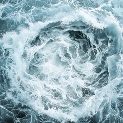 Fototapeta premium Dynamic swirling ocean waves in shades of blue and white, creating a mesmerizing abstract pattern.