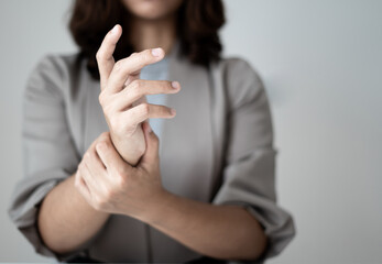 Woman hand with wrist pain numbness and pain in the palm of the hand has pain and tingling in the nerve endings This is a side effect of sitting and working for a long time on a laptop at the office