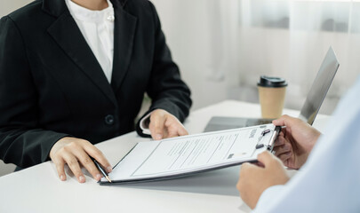 Business people hold a resume and talk to job applicants for job interviews about careers and Their personal history in the company. Recruitment concepts