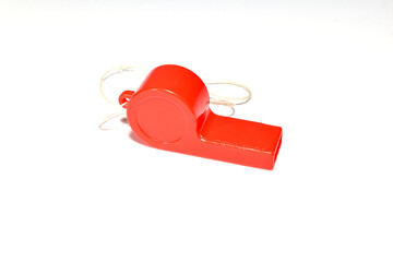 Red plastic whistle on a white background.