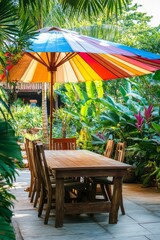 Fototapeta premium Tropical garden patio table, chairs, umbrella.