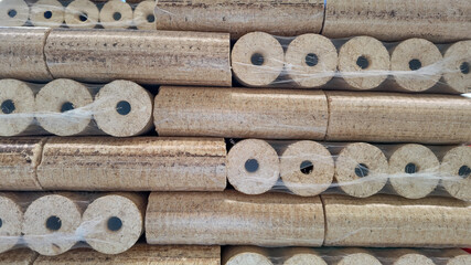 Stacked wood briquettes wrapped in plastic, showcasing renewable energy resources and eco-friendly heating solutions