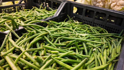 Fresh green beans in crates at a farmer's market highlight sustainable agriculture and Thanksgiving...