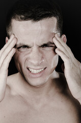Fototapeta premium Health issues. Young attractive man and headache.
