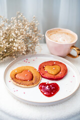 Homemade pancakes with strawberry sauce, cappuccino, woman day morning concept, Valentine's day, February