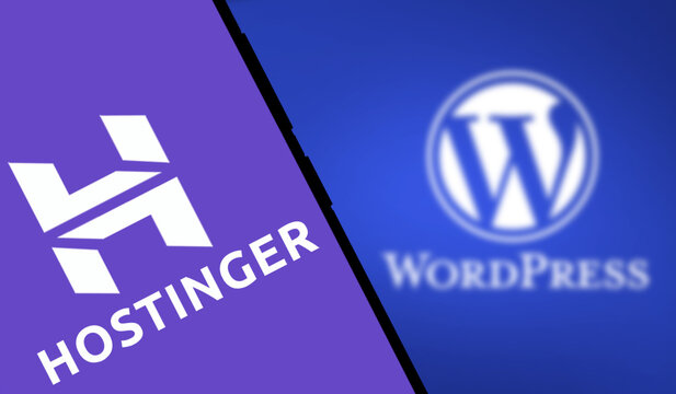 Dhaka, Bangladesh- 21 Nov 2024: hostinger logo is displayed on smartphone and WordPress logo on the background.