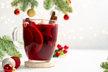 A glass of red wine with a cinnamon stick in it