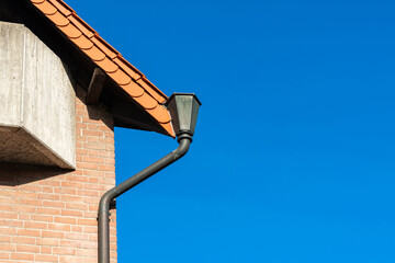 A close-up of the corner roof and roof gutter on an building. © Viktor