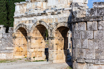 Ancient Frontinus Gates of Hierapolis, showcasing well-preserved stone arches and walls, ideal for historical, architectural, and archaeological content. Pamukkale, Denizli, Turkey (Turkiye)
