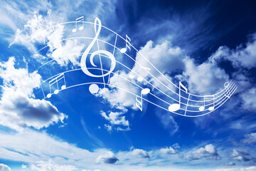Naklejka premium Musical symbols in beautiful sky with clouds