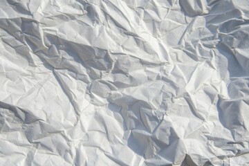 Obraz premium High-resolution image of crumpled white paper texture with light and shadow details