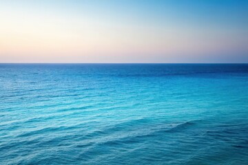 Fototapeta premium Serene Ocean Panorama A Tranquil View of Endless Azure Waters Under a Pastel Sky