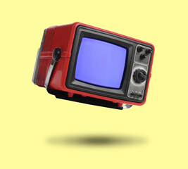 Retro TV set in air on yellow background
