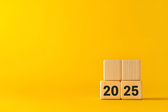 2025: New Year, Fresh Start. Minimalist Wooden Blocks on Vibrant Yellow Background. A symbol of hope and new beginnings.