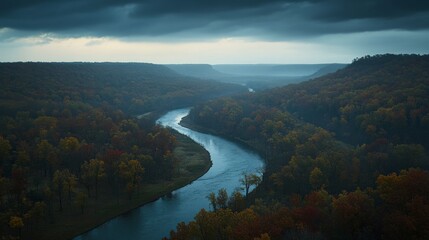Obraz premium Serene Aerial View of Winding River Surrounded by Autumn Foliage and Dramatic Clouds Overhead in a Picturesque Natural Landscape