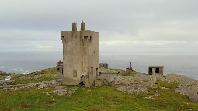 Aerial dolly approaches Malin Signal Tower with the Atlantic Ocean in view