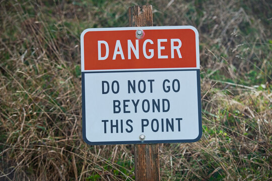 Close-up of a Danger Do Not Go Beyond This Point Sign in rural landscape, USA