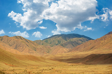 The breathtaking desert mountain landscape of Central Asia under the stunningly beautiful sky captivates all who look at it. The Tien Shan Mountains from Kazakhstan, Almaty.