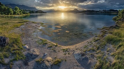 Obraz premium Serene lakeside view with mountains and a sunset, showcasing nature's beauty.