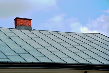 A building with a sloping tin roof.