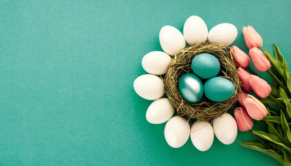 Colored  Easter eggs blue and azure in nest top view background, poster, banner, layout space for...