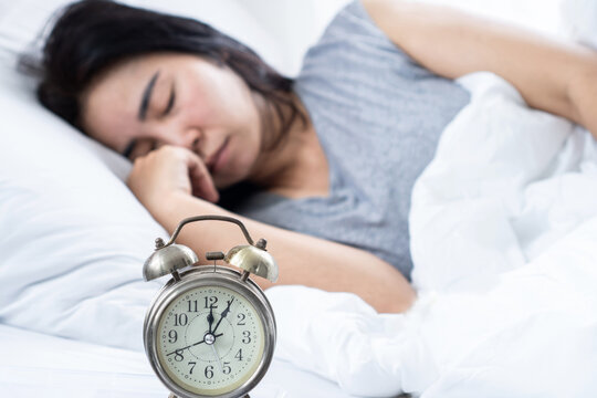 Hypersomnia and oversleeping concept with Asian woman spending ten or more hours sleeping in bed