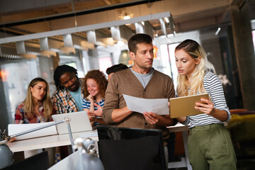Diverse business colleagues gather in boardroom brainstorm discuss financial statistics together