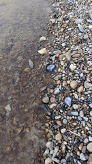Background river pebbles stones with a river, with a border of the connection of water with stones.