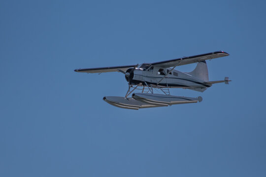 Seaplane in flight against a blue sky, British Columbia, Canada