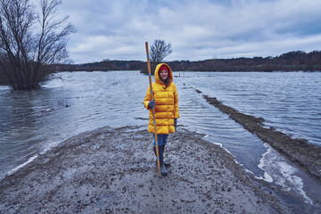 Woman checking water in flood in polish village