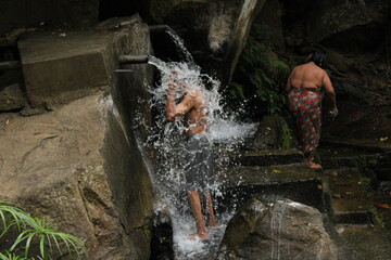 man under waterfall