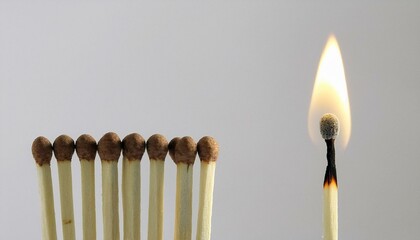 burning match with unlit matches