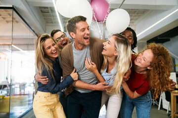 Group portrait of young startup business team celebrating success in the office